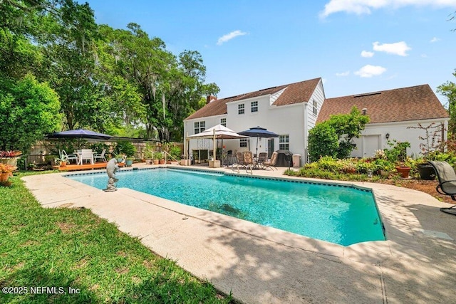 view of swimming pool featuring a fenced in pool, fence, a patio, and a gazebo
