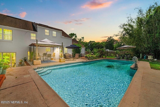 view of swimming pool featuring a patio, a gazebo, and a fenced in pool