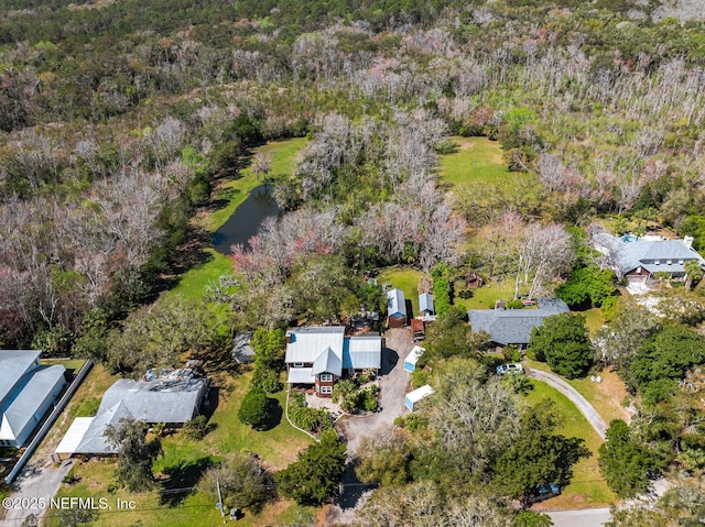 aerial view featuring a water view and a view of trees