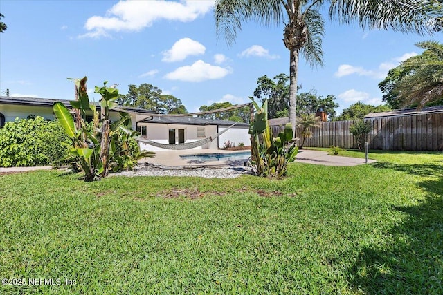 view of yard with a fenced backyard, a fenced in pool, and a patio area