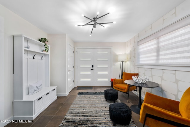 2740 Loja St, Saint Augustine, FL 32084 - mudroom with a chandelier, baseboards, and dark tile patterned flooring