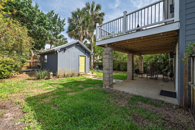 2740 Loja St, Saint Augustine, FL 32084 - view of yard with an outdoor structure, a wooden deck, fence, and a patio area