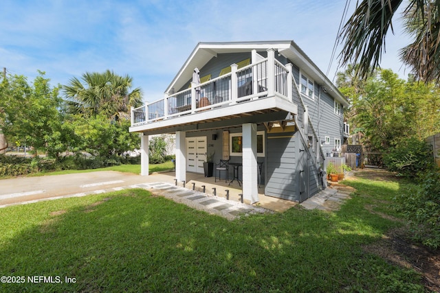 2740 Loja St, Saint Augustine, FL 32084 - view of front of home featuring fence, a patio area, a front yard, and a wooden deck