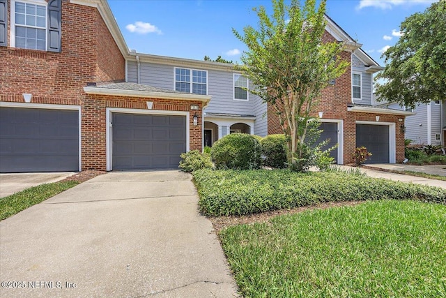 13529 Stone Pond Dr, Jacksonville, FL 32224 - townhome / multi-family property featuring brick siding, driveway, and an attached garage