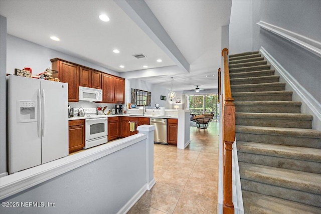 13529 Stone Pond Dr, Jacksonville, FL 32224 - kitchen featuring white appliances, a peninsula, a sink, recessed lighting, and light countertops