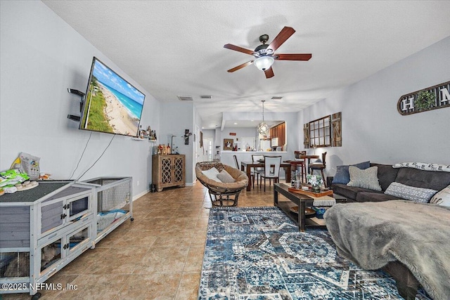 13529 Stone Pond Dr, Jacksonville, FL 32224 - living area featuring a ceiling fan, a textured ceiling, and baseboards