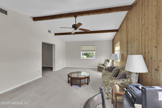 living area featuring a ceiling fan, vaulted ceiling with beams, wooden walls, carpet floors, and visible vents