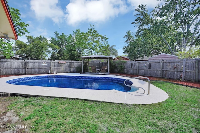 view of pool with a gazebo, a fenced backyard, a yard, a patio, and a fenced in pool