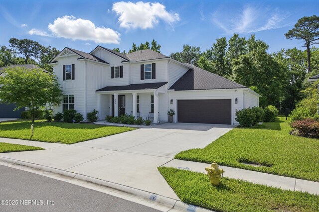177 Windwalker Dr, Saint Augustine, FL 32092 - modern farmhouse style home featuring a garage, driveway, and a front lawn