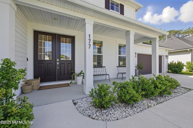 177 Windwalker Dr, Saint Augustine, FL 32092 - doorway to property featuring a porch, driveway, and a garage