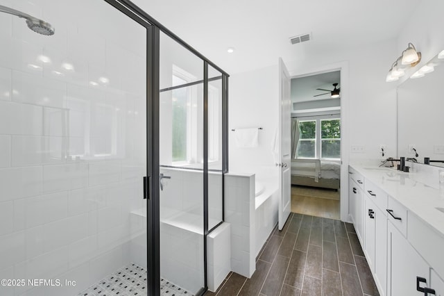 177 Windwalker Dr, Saint Augustine, FL 32092 - ensuite bathroom featuring a shower stall, a ceiling fan, a garden tub, and double vanity
