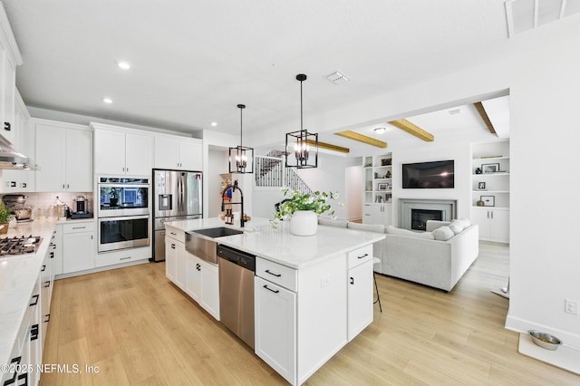 177 Windwalker Dr, Saint Augustine, FL 32092 - kitchen with stainless steel appliances, a sink, recessed lighting, light wood finished floors, and beamed ceiling