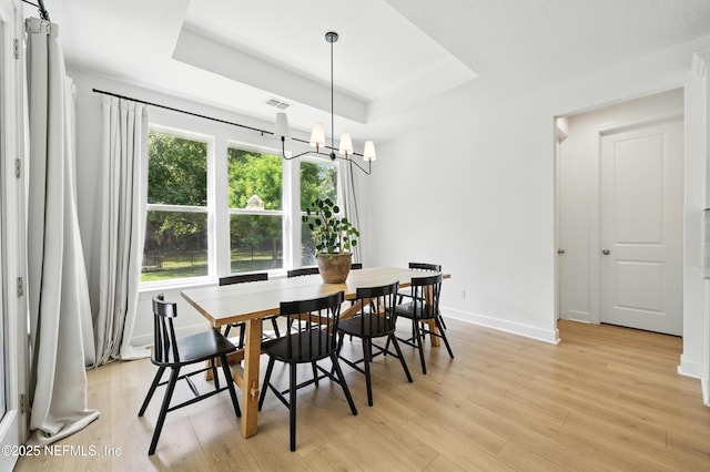 177 Windwalker Dr, Saint Augustine, FL 32092 - dining room with a raised ceiling, a chandelier, light wood-style floors, and baseboards