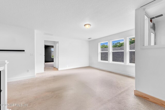 177 Windwalker Dr, Saint Augustine, FL 32092 - spare room featuring carpet flooring, baseboards, and a textured ceiling