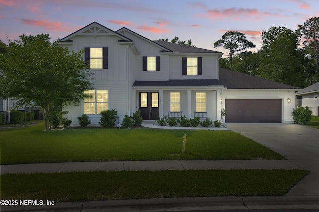 177 Windwalker Dr, Saint Augustine, FL 32092 - modern farmhouse featuring an attached garage, driveway, a front lawn, and board and batten siding