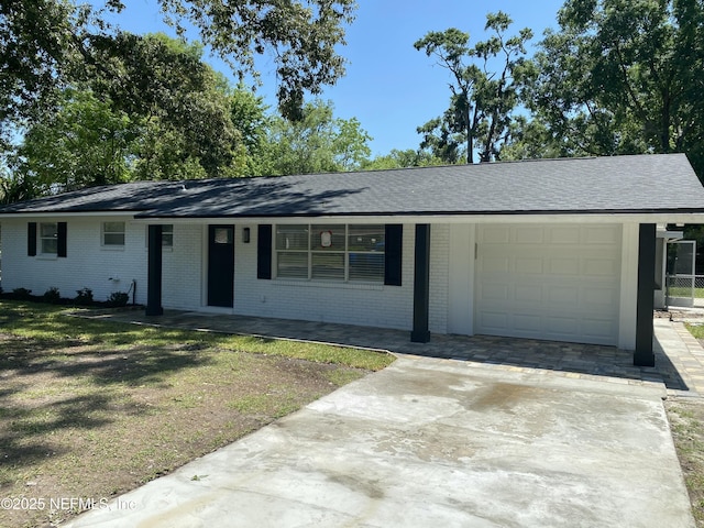 single story home featuring concrete driveway, brick siding, covered porch, and a garage