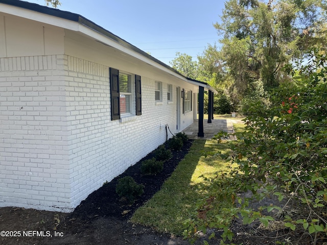 view of property exterior featuring brick siding