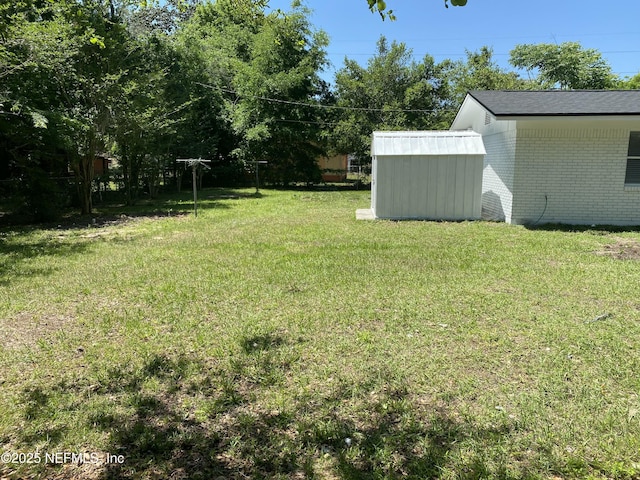 view of yard with an outdoor structure and a storage unit