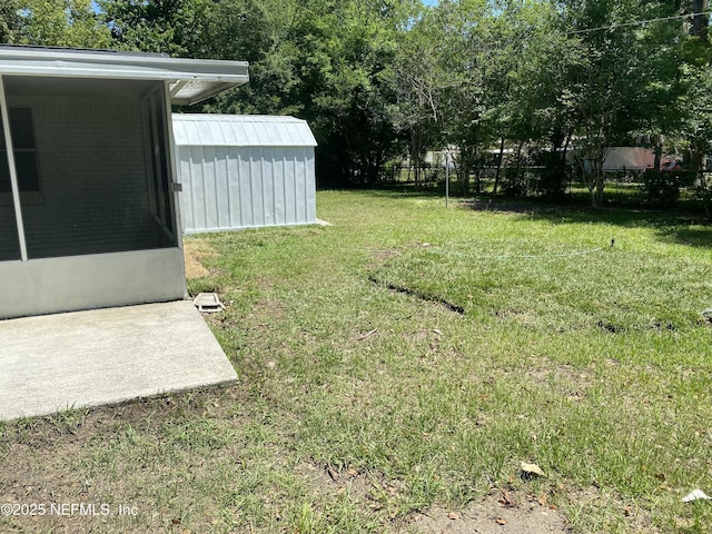 view of yard with an outbuilding, a shed, and fence