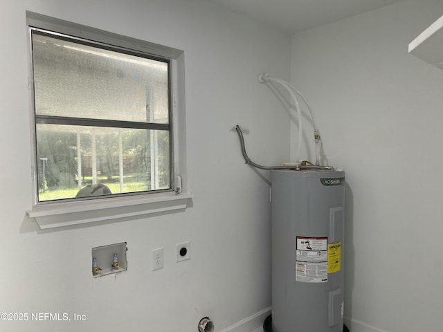 washroom with electric water heater, baseboards, hookup for a washing machine, electric dryer hookup, and laundry area