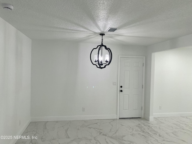 unfurnished dining area with visible vents, marble finish floor, baseboards, and a notable chandelier