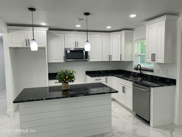 kitchen with marble finish floor, appliances with stainless steel finishes, and visible vents