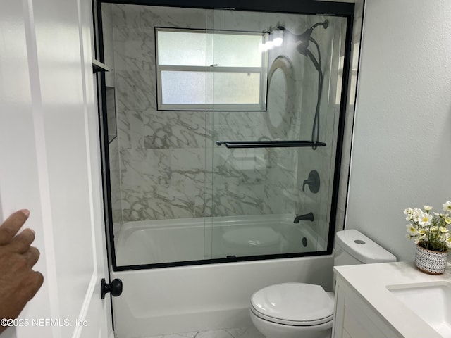 bathroom with vanity, enclosed tub / shower combo, marble finish floor, and toilet