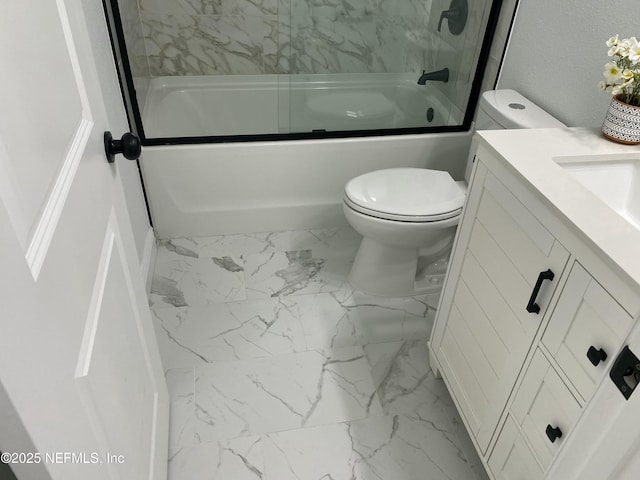 bathroom with vanity, marble finish floor, toilet, and bath / shower combo with glass door