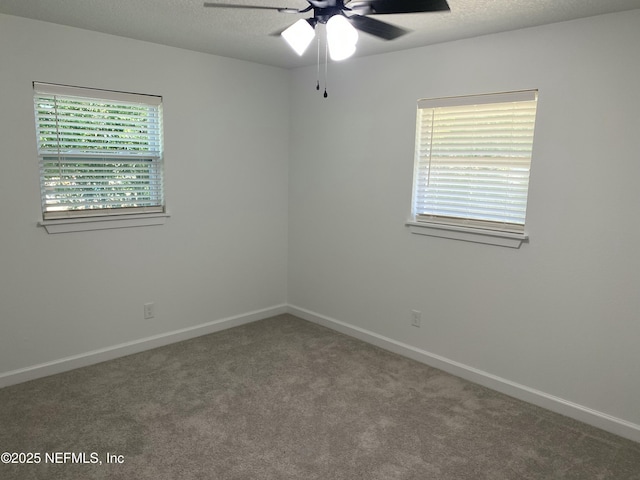 carpeted empty room with baseboards and ceiling fan