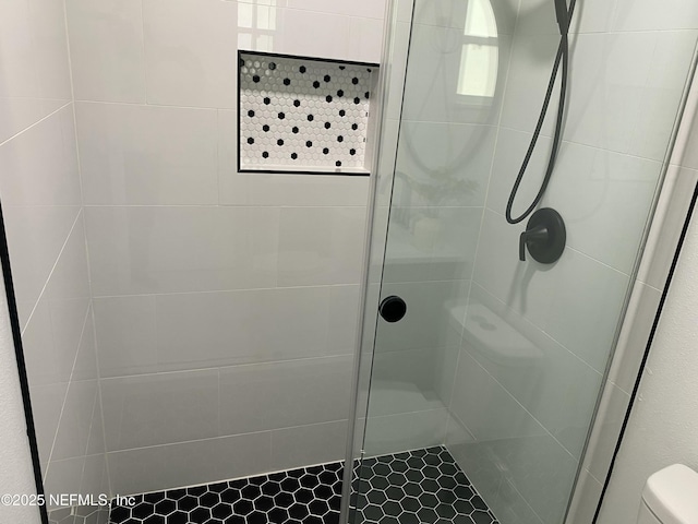 full bath with toilet and a stall shower