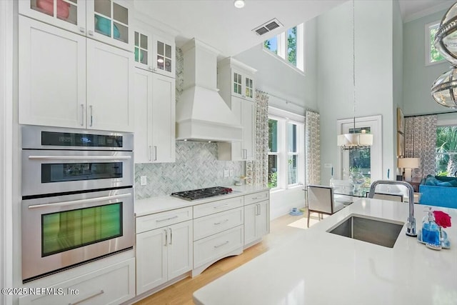 36 Preserve Island Cir, Ponte Vedra Beach, FL 32082 - kitchen featuring a sink, custom range hood, visible vents, a towering ceiling, and appliances with stainless steel finishes