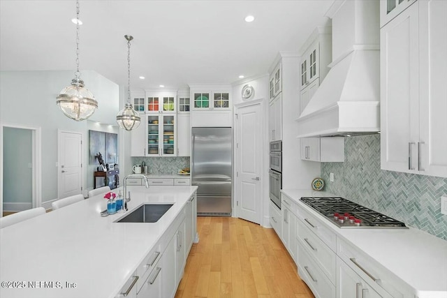 36 Preserve Island Cir, Ponte Vedra Beach, FL 32082 - kitchen with a sink, stainless steel appliances, light countertops, custom exhaust hood, and backsplash