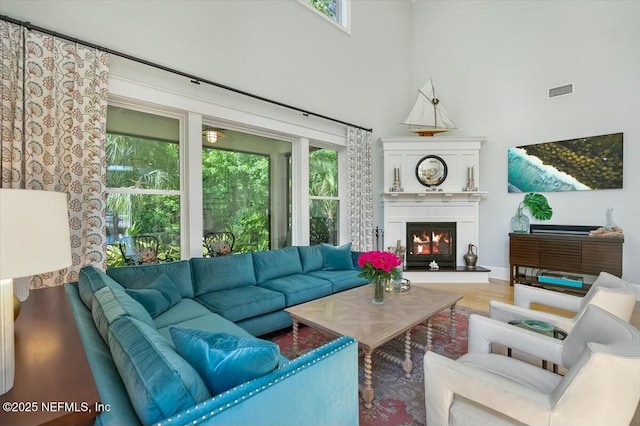 36 Preserve Island Cir, Ponte Vedra Beach, FL 32082 - living room featuring visible vents, wood finished floors, plenty of natural light, and a lit fireplace