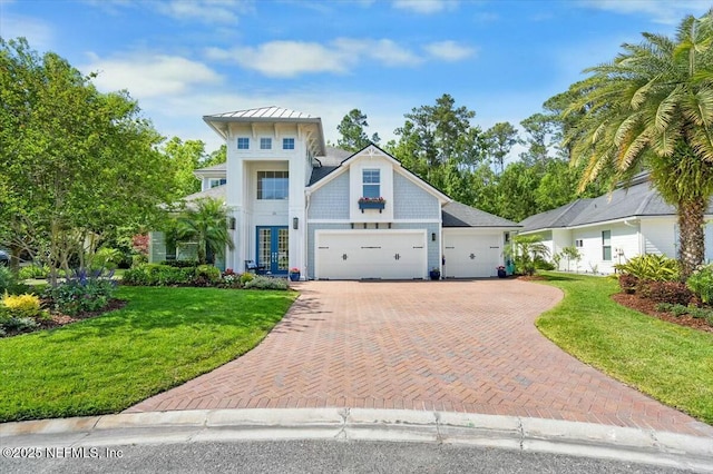 36 Preserve Island Cir, Ponte Vedra Beach, FL 32082 - view of front of property with a front yard, decorative driveway, an attached garage, and a standing seam roof