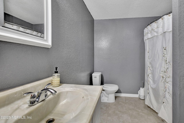 full bathroom with tile patterned floors, a textured ceiling, vanity, a textured wall, and toilet