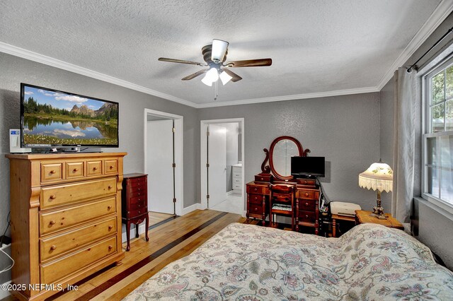 bedroom featuring a textured wall, wood finished floors, a textured ceiling, and ornamental molding