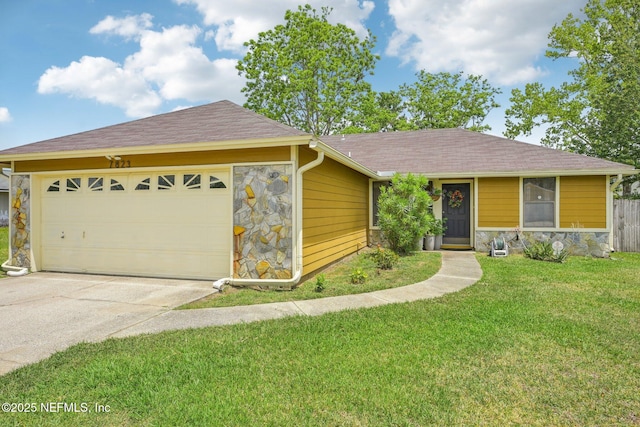 ranch-style home featuring driveway, stone siding, a shingled roof, a front yard, and a garage