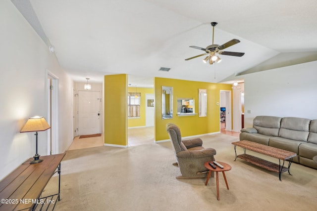 living room featuring lofted ceiling, visible vents, ceiling fan, baseboards, and light carpet