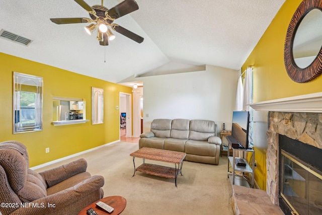carpeted living room featuring visible vents, a healthy amount of sunlight, a ceiling fan, and vaulted ceiling