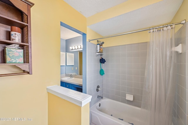 full bath featuring shower / bath combo, vanity, and a textured ceiling
