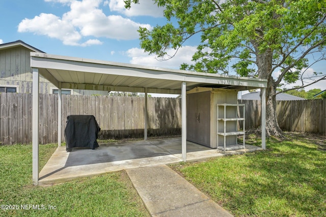 view of vehicle parking featuring a storage shed and a fenced backyard