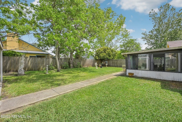 view of yard with a fenced backyard and a sunroom