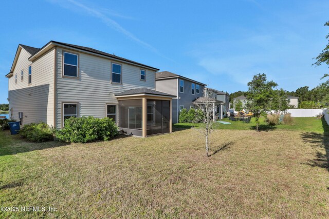 383 Narrowleaf Dr, Saint Johns, FL 32259 - rear view of property with a sunroom and a yard
