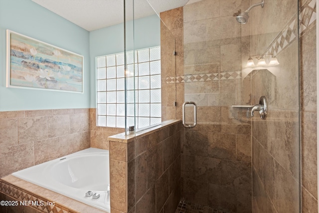 full bathroom featuring a bath and a stall shower
