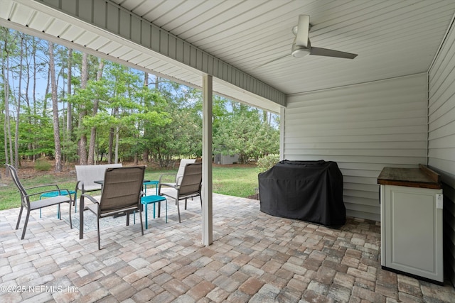 view of patio featuring a ceiling fan, outdoor dining space, and grilling area