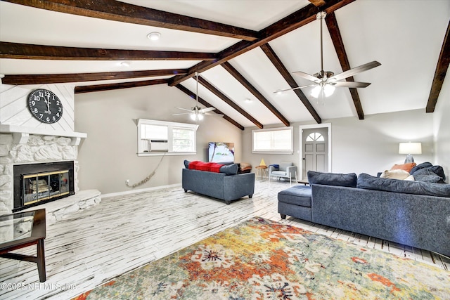 living area featuring a ceiling fan, a fireplace, wood finished floors, baseboards, and lofted ceiling with beams