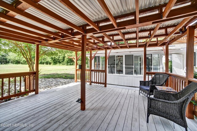 deck featuring a lawn and a sunroom