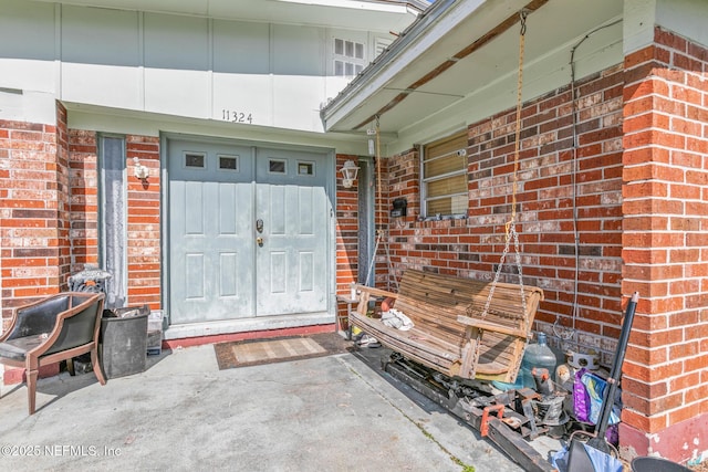 entrance to property with brick siding