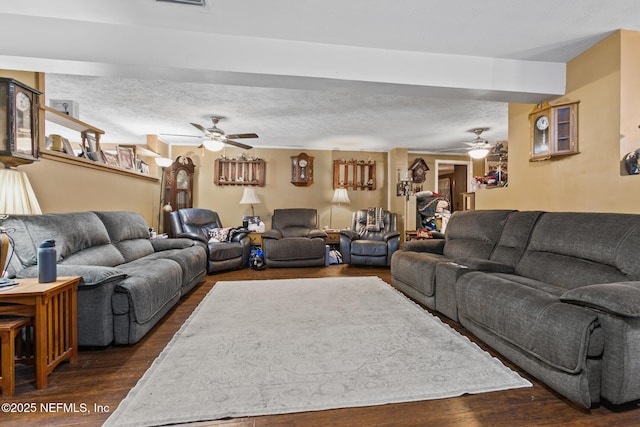 living room with visible vents, a ceiling fan, and dark wood-style floors