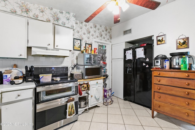 kitchen with a ceiling fan, wallpapered walls, stainless steel appliances, under cabinet range hood, and visible vents